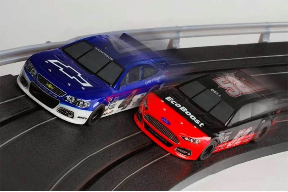A blue car racing with a red car